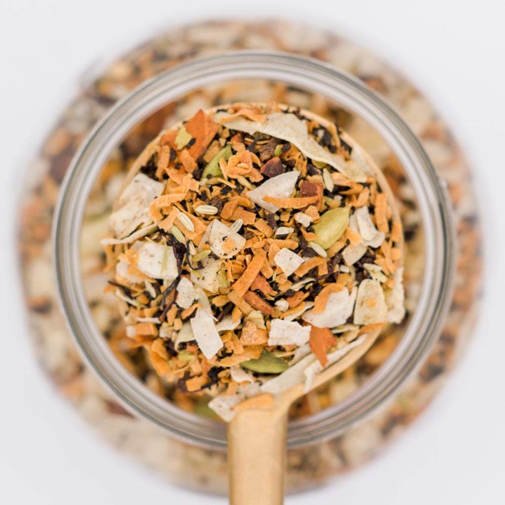 Coconut Mela Loose Leaf Tea Blend Scoop. Made with black tea, roasted coconut,  cardamom, fennel, cloves, ginger, cinnamon and vanilla.