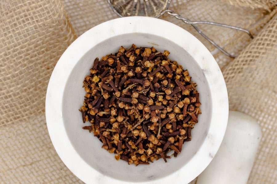 Cloves in a mortar bowl. Cloves are great for cooking, baking and making desserts. The perfect addition to your pantry. 