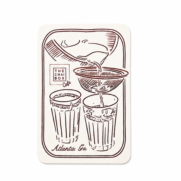 chai pouring into two cups with The Chai Box Cafe logo