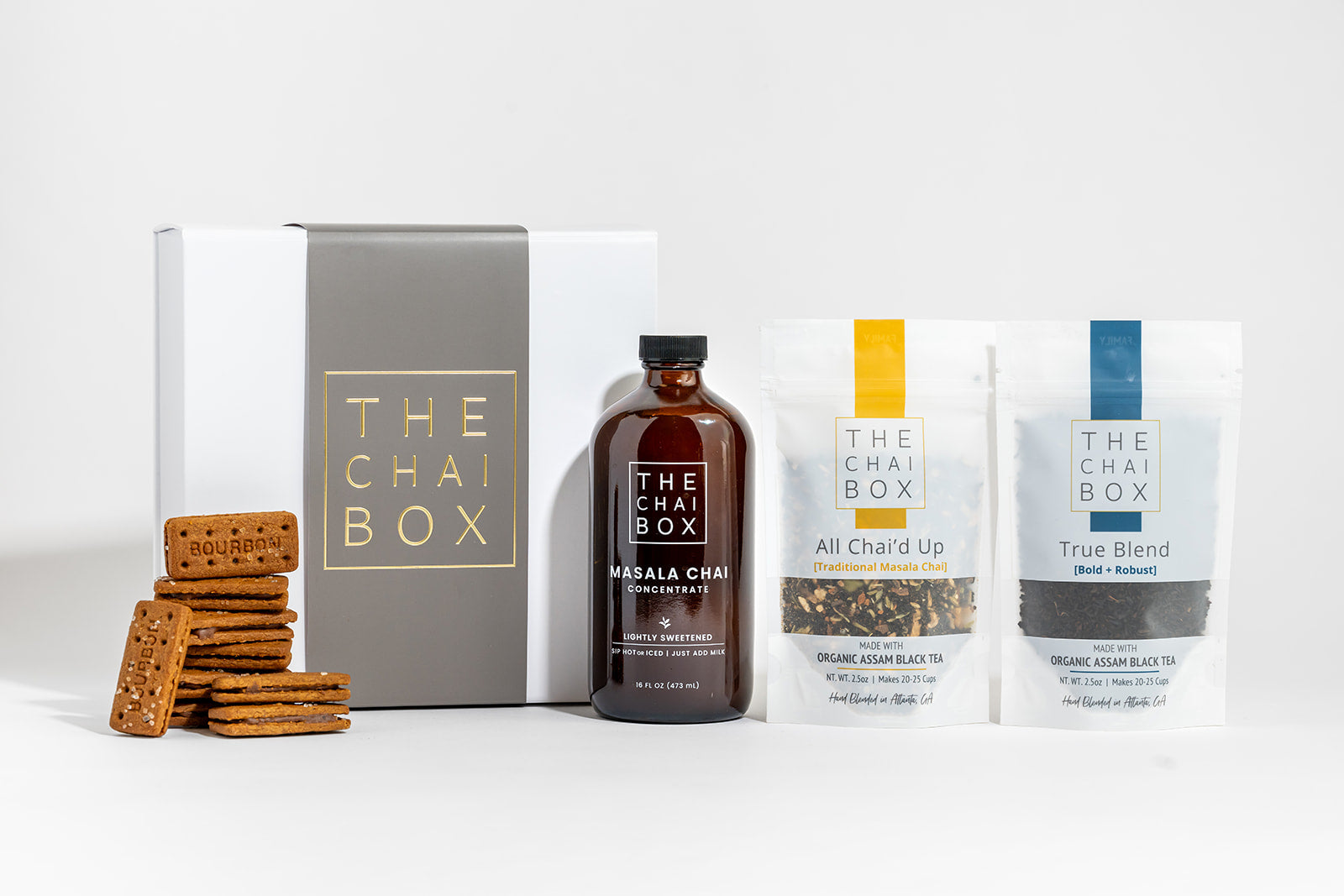 The Chai Box Gift Set including a magnetic box, Chai Concentrate, and loose-leaf tea with a pack of chocolate biscuits