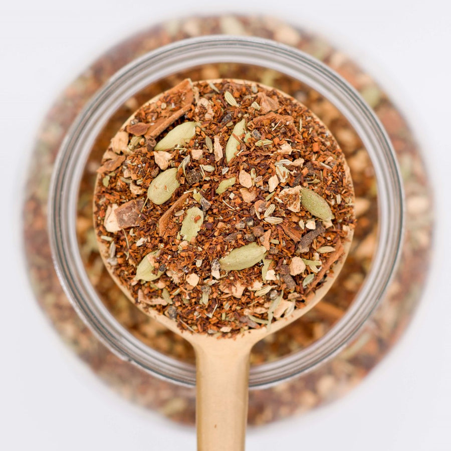 All Chai'd Up Loose Leaf Tea Scooped in spoon. Made with rooibos leaves, ginger, cinnamon, cardamon, fennel seeds and cloves. 
