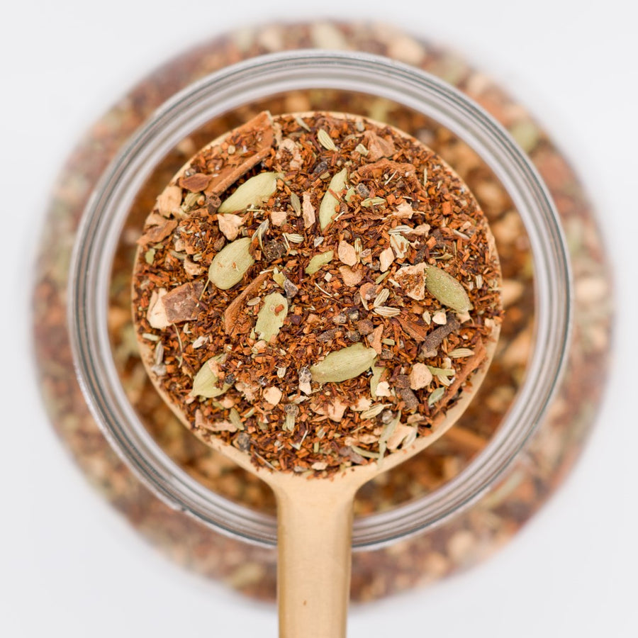 All Chai'd Up Rooibos Decaf Loose Leaf Tea Scooped in spoon. Made with rooibos leaves, ginger, cinnamon, cardamon, fennel seeds and cloves.