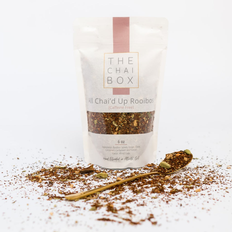 The Chai Box All Chai'd Up Rooibos Caffeine Free Loose Leaf Tea Blend bag with spoon. All Chai'd Up Rooibos is an infusion of Western and Eastern flavors.
