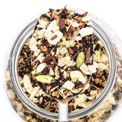 Coconut Mela Loose Leaf Tea Blend Scoop. Made with black tea, roasted coconut, cardamom, fennel, cloves, ginger, cinnamon and vanilla