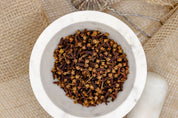 Cloves in a mortar bowl. Cloves are great for cooking, baking and making desserts. The perfect addition to your pantry. 