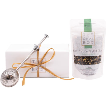 The Chai Box Kick Cancer's Ass Gift Set for tea lovers. Includes a bag of Kick Cancer's Ass Chai loose leaf tea blend and a tea steeper.